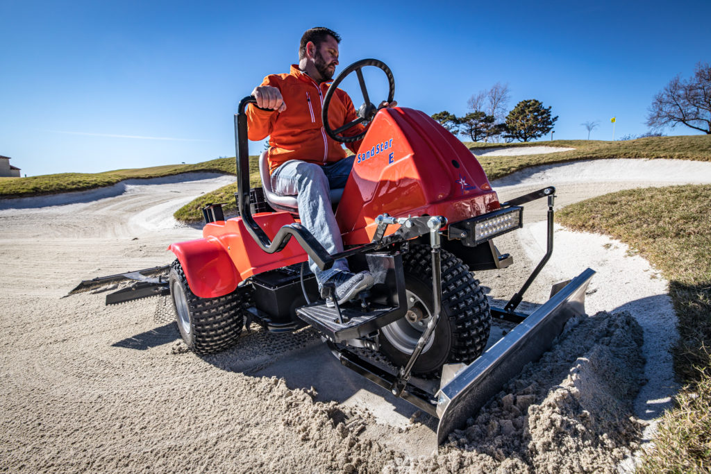 Sand Star E bunker rake in use on a sand trap